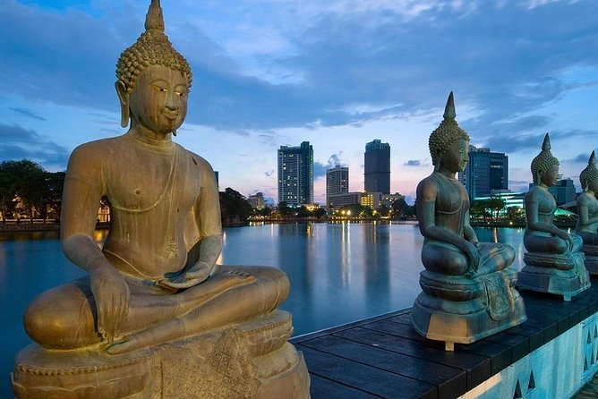 Buddha statues at Seema Malaka on Beira Lake with the Colombo skyline behind